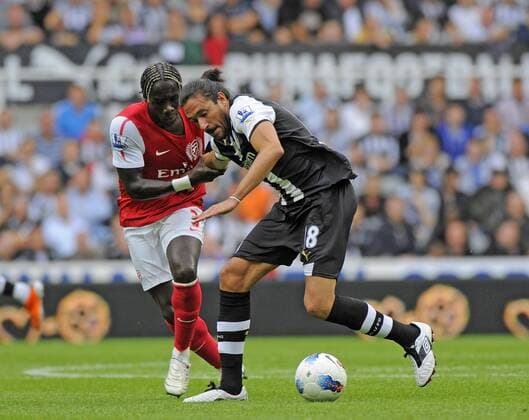 Jonas Gutierrez of Newcastle United (R) holds off Bacary Sagna of Arsenal during the Premier League football match between Newcastle United and Arsenal FC London on 13 August, 2011, at St. James Park, Newcastle upon Tyne, England. Barclays Premier League 2011 EDITORIAL USE ONLY. No use with unauthorised audio, video, data, fixture lists, club league logos or live services. Online in-match use limited to 120 images, no video emulation. No use in betting, games or single club league player publications.