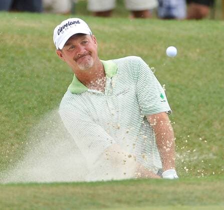 Jerry Kelly chips out of a bunker onto the 1st green during the third round of the 93rd PGA Golf Herren Championship at the Atlanta Athletic Club on August 13, 2011 in Johns Creek, Georgia.  BKX2011081304