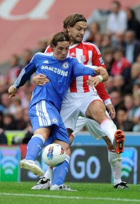 Fernando Torres of Chelsea tackled by Jonathan Woodgate of Stoke City Barclays Premier League Stoke City v Chelsea 14th August, 2011 EDITORIAL USE ONLY. No use with unauthorised audio, video, data, fixture lists, club league logos or live services. Online in-match use limited to 120 images, no video emulation. No use in betting, games or single club league player publications.
