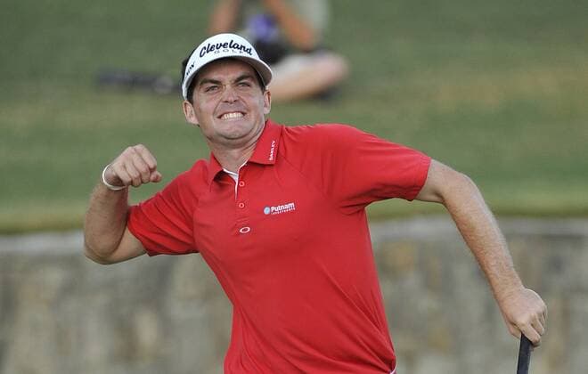 Keegan Bradley raises his arm after sinking a par putt on the 18th hole to win the 93rd PGA Golf Herren Championship at the Atlanta Athletic Club on August 14, 2011 in Johns Creek, Georgia. Bradley defeated Jason Dufner in a three-hole playoff to win the tournament by one stroke.  BKX2011081422