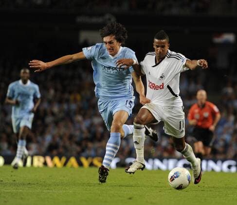 Stefan Savic of Manchester City tussles with Scott Sinclair of Swansea City Barclays Premier League Manchester City v Swansea City 15th August, 2011 EDITORIAL USE ONLY. No use with unauthorised audio, video, data, fixture lists, club league logos or live services. Online in-match use limited to 120 images, no video emulation. No use in betting, games or single club league player publications.