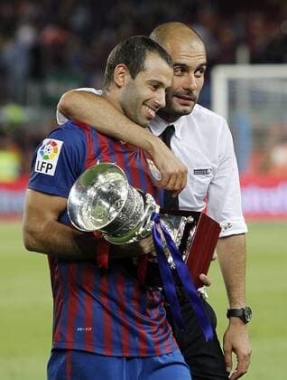 FC Barcelona s coach Josep Pep Guardiola (r) and Javier Mascherano celebrates the victory during Spanish Supercup 2nd match, August 17,2011.  (201108174194) o0 Sieg Feier Objekte Trophäe