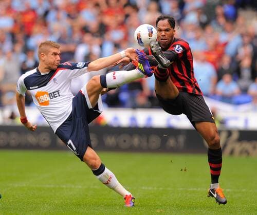 Ivan Klasnic of Bolton Wanderers tussles with Joleen Lescott of Manchester City Barclays Premier League. Bolton Wanderers vs Manchester City. 21st August, 2011 EDITORIAL USE ONLY. No use with unauthorised audio, video, data, fixture lists, club league logos or live services. Online in-match use limited to 120 images, no video emulation. No use in betting, games or single club league player publications.