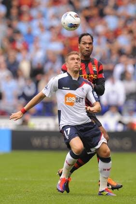 Ivan Klasnic of Bolton Wanderers tussles with Joleen Lescott of Manchester City Barclays Premier League. Bolton Wanderers vs Manchester City. 21st August, 2011 EDITORIAL USE ONLY. No use with unauthorised audio, video, data, fixture lists, club league logos or live services. Online in-match use limited to 120 images, no video emulation. No use in betting, games or single club league player publications.