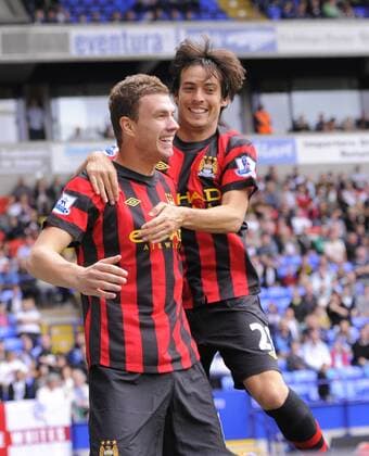Edin Dzeko of Manchester City celebrates scoring the third goal with David Silva of Manchester City Barclays Premier League. Bolton Wanderers vs Manchester City. 21st August, 2011 EDITORIAL USE ONLY. No use with unauthorised audio, video, data, fixture lists, club league logos or live services. Online in-match use limited to 120 images, no video emulation. No use in betting, games or single club league player publications.