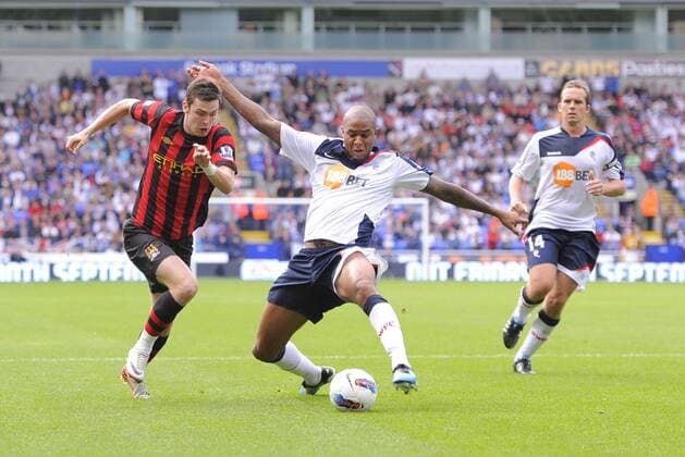 Zat Knight of Bolton Wanderers stretches to intercept Adam Johnson of Manchester City Barclays Premier League. Bolton Wanderers vs Manchester City 21st August, 2011 EDITORIAL USE ONLY. No use with unauthorised audio, video, data, fixture lists, club league logos or live services. Online in-match use limited to 120 images, no video emulation. No use in betting, games or single club league player publications.