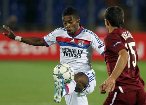 ITAR-TASS: KAZAN, RUSSIA. AUGUST 24, 2011. French FC Lyonâ€™s Michel Bastos (white) and Russian FC Rubin Kazanâ€™s Syarhey Kislyak (red) struggle for the ball in their UEFA Champions League game at Central Stadium in the city of Kazan.  RE0ECA43