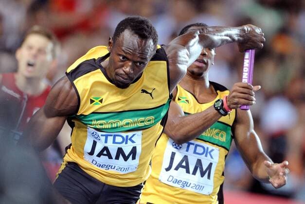(110904) -- DAEGU, Sept. 4, 2011 (Xinhua) -- Usain Bolt(L) of team of Jamaica holds the baton handed from his teammate during the men s 4x100 metres relay final at the IAAF World Championships in Daegu, South Korea, on Sept. 4, 2011. (Xinhua Chen Xiaowei) SOUTH KOREA-DAEGU-IAAF-WORLD CHAMPIONSHIPS-DAY 9 