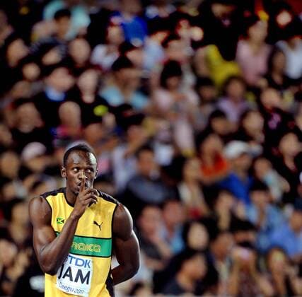 DAEGU, Sept. 4, 2011 -- Usain Bolt of Jamaica makes a shush gesture before taking the baton from teammate in the men s 4x100 metres relay final at the IAAF World Athletics Championships in Daegu, September 4, 2011. Jamaica won the gold of the event in 37.04 seconds and set a new world record. (Xinhua Chen Xiaowei) 