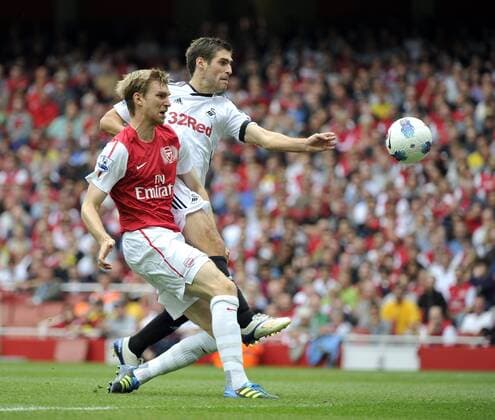 Premier League Arsenal v Swansea Danny Graham and Per Mertesacker head for goal 