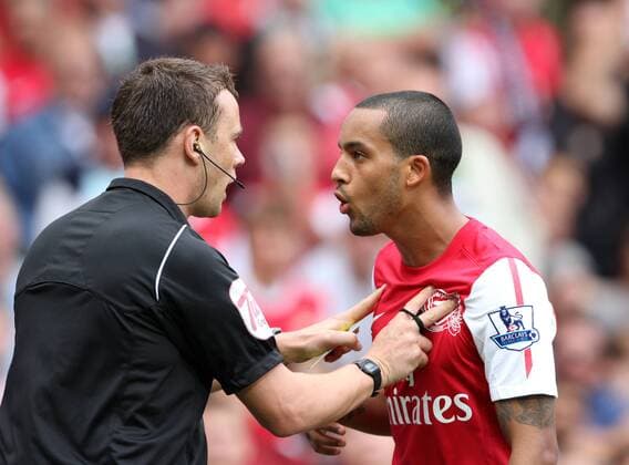 Arsenals Theo Walcott appears to get pushed by referee Stuart Attwell Barclays Premier League Arsenal FC v Swansea City 10th September, 2011 EDITORIAL USE ONLY. No use with unauthorised audio, video, data, fixture lists, club league logos or live services. Online in-match use limited to 120 images, no video emulation. No use in betting, games or single club league player publications.