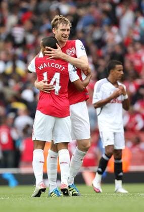 Arsenals Per Mertesacker celebrates with Theo Walcott at the final whistle Barclays Premier League Arsenal FC v Swansea City 10th September, 2011 EDITORIAL USE ONLY. No use with unauthorised audio, video, data, fixture lists, club league logos or live services. Online in-match use limited to 120 images, no video emulation. No use in betting, games or single club league player publications.