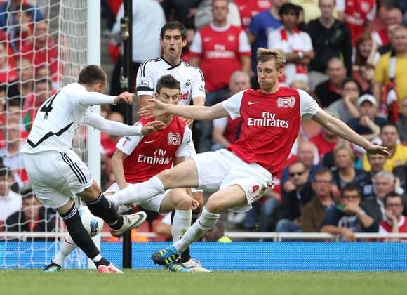 Arsenals Per Mertsacker blocks Swanseas Joe Allen shot Barclays Premier League Arsenal FC v Swansea City 10th September, 2011 EDITORIAL USE ONLY. No use with unauthorised audio, video, data, fixture lists, club league logos or live services. Online in-match use limited to 120 images, no video emulation. No use in betting, games or single club league player publications.