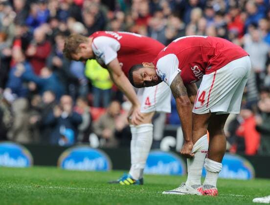 Dejected Theo Walcott of Arsenal and Per Mertesacker of Arsenal Barclays Premier League - Blackburn Rovers vs. Arsenal FC London - 17th September, 2011 EDITORIAL USE ONLY. No use with unauthorised audio, video, data, fixture lists, club league logos or live services. Online in-match use limited to 120 images, no video emulation. No use in betting, games or single club league player publications.