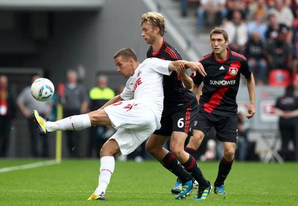 17.09.2011, Leverkusen, Deutschland, 1.Fussball Bundesliga - Saison 2011 2012, Bayer 04 Leverkusen - 1.FC Köln, Leverkusens Simon Rolfes gegen Kölns Lukas Podolski der mit der Aktion das 0:1 eingeleitet hat 2 .