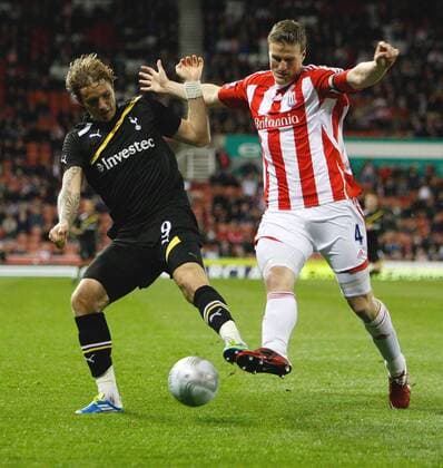 Tottenham Hotspur s Roman Pavlyuchenko battles with Stoke City s Robert Huth Carling Cup Stoke City v Tottenham Hotspur 20th September, 2011 EDITORIAL USE ONLY. No use with unauthorised audio, video, data, fixture lists, club league logos or live services. Online in-match use limited to 120 images, no video emulation. No use in betting, games or single club league player publications.