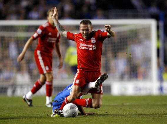 Craig Bellamy of Liverpool is tackled by Alan Navarro of Brighton & Hove Albion during the League Cup match, Brighton Hove Albion - Liverpool FC EDITORIAL USE ONLY. No use with unauthorised audio, video, data, fixture lists, club league logos or live services. Online in-match use limited to 120 images, no video emulation. No use in betting, games or single club league player publications.