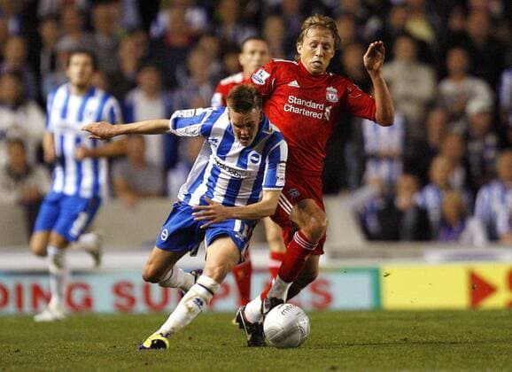 Craig Noone of Brighton & Hove Albion holds off Lucas Leiva of Liverpool during the League Cup match, Brighton Hove Albion - Liverpool FC EDITORIAL USE ONLY. No use with unauthorised audio, video, data, fixture lists, club league logos or live services. Online in-match use limited to 120 images, no video emulation. No use in betting, games or single club league player publications.