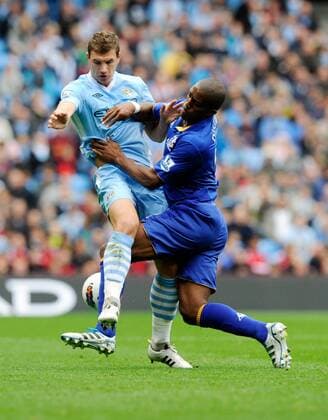 Edin Dzeko of Manchester City tangles with Sylvain Distin of Everton Barclays Premier League Manchester City v Everton 24th September, 2011 EDITORIAL USE ONLY. No use with unauthorised audio, video, data, fixture lists, club league logos or live services. Online in-match use limited to 120 images, no video emulation. No use in betting, games or single club league player publications.