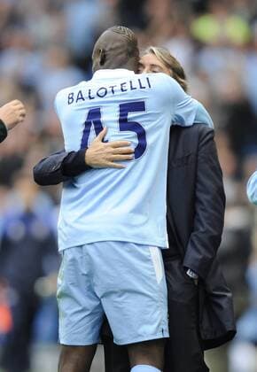 Mario Balotelli of Manchester City runs over to hug Roberto Mancini manager of Manchester City after scoring the first goal Barclays Premier League Manchester City v Everton 24th September, 2011 EDITORIAL USE ONLY. No use with unauthorised audio, video, data, fixture lists, club league logos or live services. Online in-match use limited to 120 images, no video emulation. No use in betting, games or single club league player publications.