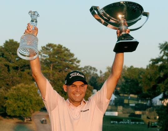 Bill Haas of Greenville, S.C., holds up the Tour Championship, left, and FedExCup trophies after winning the Tour Championship golf tournament in a three-hole playoff against Hunter Mahan at the East Lake Golf Club in Atlanta, Georgia, on Sunday, September 25, 2011.  ATL20110925315 Fed Ex