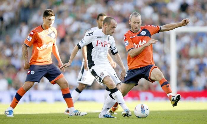 Danny Murphy of Fulham holds off Shaun Derry of Queens Park Rangers during the Premier League match between Fulham and Queens Park Rangers at Craven Cottage, London, England, on October 2, 2011. Barclays Premier League - Fulham FC vs. Queens Park Rangers (QPR) 2nd October, 2011 EDITORIAL USE ONLY. No use with unauthorised audio, video, data, fixture lists, club league logos or live services. Online in-match use limited to 120 images, no video emulation. No use in betting, games or single club league player publications.