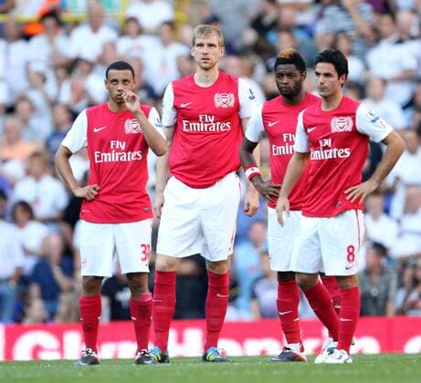 Arsenals players with Per Mertesacker look on dejected Barclays Premier League - Tottenham Hotspur vs. Arsenal FC London - 2nd October, 2011 EDITORIAL USE ONLY. No use with unauthorised audio, video, data, fixture lists, club league logos or live services. Online in-match use limited to 120 images, no video emulation. No use in betting, games or single club league player publications.