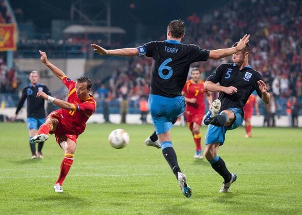 Vladimir Bozovic of Montenegro scores their first goal past John Terry and Gary Cahill of England European Championship Qualifying Group G Montenegro v England 7th October, 2011 EDITORIAL USE ONLY. No use with unauthorised audio, video, data, fixture lists, club league logos or live services. Online in-match use limited to 120 images, no video emulation. No use in betting, games or single club league player publications. Euro Podgorica o0 Tor