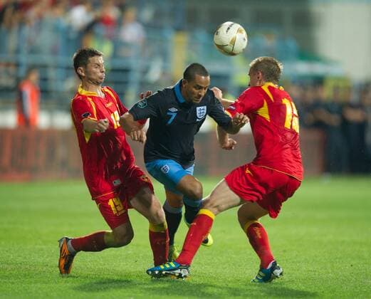 Theo Walcott of England is fouled by Vladimir Bozovic and Milorad Petkovic of Montenegro European Championship Qualifying Group G Montenegro v England 7th October, 2011 EDITORIAL USE ONLY. No use with unauthorised audio, video, data, fixture lists, club league logos or live services. Online in-match use limited to 120 images, no video emulation. No use in betting, games or single club league player publications. o00 Euro