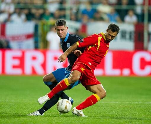 Gary Cahill of England shadows Mirko Vucinic of Montenegro European Championship Qualifying Group G Montenegro v England 7th October, 2011 EDITORIAL USE ONLY. No use with unauthorised audio, video, data, fixture lists, club league logos or live services. Online in-match use limited to 120 images, no video emulation. No use in betting, games or single club league player publications. o00 Euro