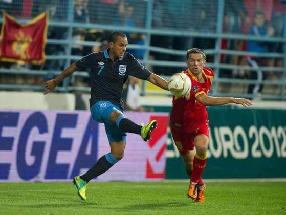 Theo Walcott of England and Vladimir Bozovic of Montenegro European Championship Qualifying Group G Montenegro v England 7th October, 2011 EDITORIAL USE ONLY. No use with unauthorised audio, video, data, fixture lists, club league logos or live services. Online in-match use limited to 120 images, no video emulation. No use in betting, games or single club league player publications. o00 Euro