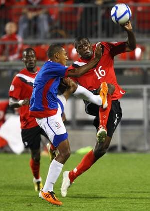 Olivier Occean (R) of Canada vies for the ball with Alexis Rivera (C) of Puerto Rico during the 2014 World Cup CONCACAF qualification match in Toronto, Canada, on Oct. 11, 2011. The match ended with a 0-0 draw.(Xinhua Zou Zheng)(ql) CANADA-TORONTO-2014 WORLD CUP CONCACAF QUALIFICATION MATCH-CANADA VS PUERTO RICO 