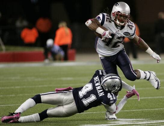 New England Patriots BenJarvus Green-Ellis (42) leaps over Dallas Cowboys cornerback Terence Newman (41) on a 7-yard carry in the fourth quarter against at Gillette Stadium in Foxboro, Massachusetts on October 16, 2011. The Patriots defeated the Cowboys 20-16.  BOS2011101611