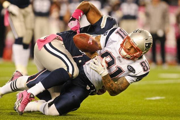 Oct. 16, 2011 - Foxborough, Massachusetts, U.S - Dallas Cowboys LB Bradie James (56) forces New England Patriots TE Aaron Hernandez (81) to fumble late in the game. The New England Patriots defeat the Dallas Cowboys 20 - 16 at Gillette Stadium. NFL American Football Herren USA 2011 - Cowboys at Patriots - ZUMAq39