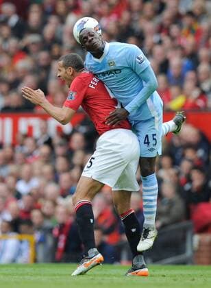 Rio Ferdinand of Manchester United beaten to the ball by Mario Balotelli of Manchester City Barclays Premier League - Manchester United ManU vs. Manchester City - 23rd October, 2011 EDITORIAL USE ONLY. No use with unauthorised audio, video, data, fixture lists, club league logos or live services. Online in-match use limited to 120 images, no video emulation. No use in betting, games or single club league player publications.