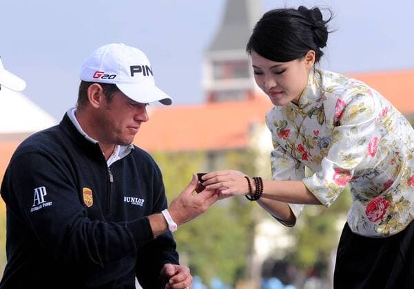 Golfer Lee Westwood of Britain, left, attends a traditional Chinese tea ceremony during a press conference for the forthcoming Lake Malaren Shanghai Masters golf tournament in Shanghai, China, 25 October 2011.  20111025_37659