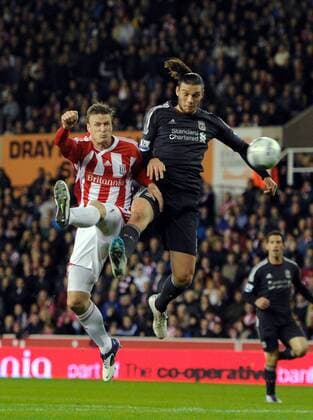 Andy Carroll of Liverpool gets in front of Robert Huth of Stoke City to direct a header goal wards Carling Cup Stoke City v Liverpool 26th October, 2011 EDITORIAL USE ONLY. No use with unauthorised audio, video, data, fixture lists, club league logos or live services. Online in-match use limited to 120 images, no video emulation. No use in betting, games or single club league player publications.