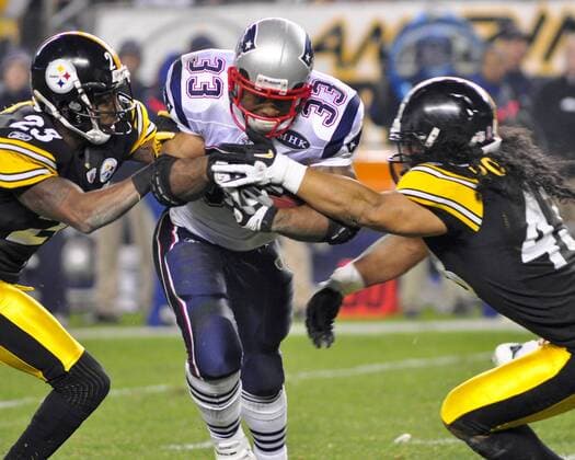 New England Patriots Kevin Faulk gains 18 yards on a short pass up the middle before Pittsburgh Steelers Troy Polamalu (43) and Ryan Clark (25) tackle him in the fourth quarter of the Pittsburgh Steelers 25-17 win at Heinz Field in Pittsburgh, Pennsylvania on October 30, 2011.  PIT2011103013