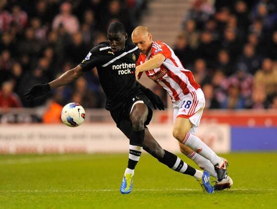 Demba Ba of Newcastle United challenged by Andy Wilkinson of Stoke City, Stoke City - Newcastle United, Stoke on Trent EDITORIAL USE ONLY. No use with unauthorised audio, video, data, fixture lists, club league logos or live services. Online in-match use limited to 120 images, no video emulation. No use in betting, games or single club league player publications.