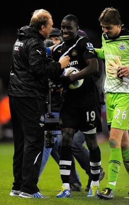Demba Ba of Newcastle United celebrates scoring his hat rick by claiming the match ball, Stoke City - Newcastle United, Stoke on Trent EDITORIAL USE ONLY. No use with unauthorised audio, video, data, fixture lists, club league logos or live services. Online in-match use limited to 120 images, no video emulation. No use in betting, games or single club league player publications.