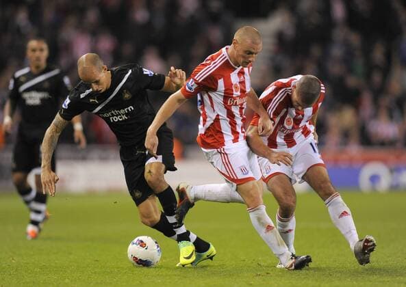 Gabriel Obertan of Newcastle United torments Andy Wilkinson of Stoke City and Jonathan Walters of Stoke City, Stoke City - Newcastle United, Stoke on Trent EDITORIAL USE ONLY. No use with unauthorised audio, video, data, fixture lists, club league logos or live services. Online in-match use limited to 120 images, no video emulation. No use in betting, games or single club league player publications.