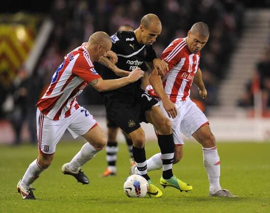Gabriel Obertan of Newcastle United torments Andy Wilkinson of Stoke City and Jonathan Walters of Stoke City, Stoke City - Newcastle United, Stoke on Trent EDITORIAL USE ONLY. No use with unauthorised audio, video, data, fixture lists, club league logos or live services. Online in-match use limited to 120 images, no video emulation. No use in betting, games or single club league player publications.