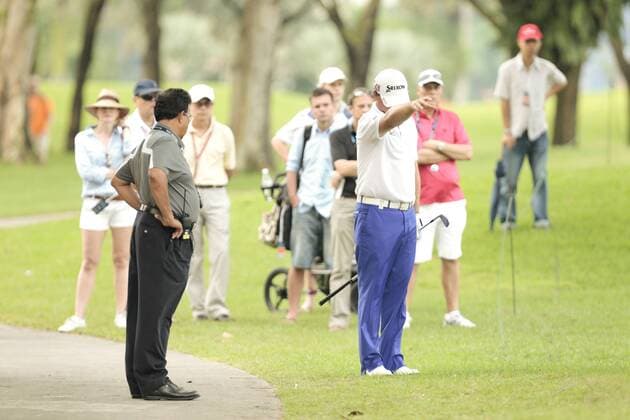 10.11.2011. Singapore. Graeme McDowell(NIR) take a free drop after his ball lands on the cart path on hole 18 Serapong Course during Round 1 of the Barclays Singapore Open 2011, Sentosa Golf Club. xDanielxSweex  ActionPlus11219706 Content restricted for UK based newspaper