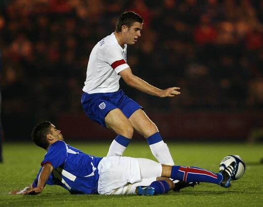 Jordan Henderson of England is tackled by Gudlaugur Victor Palsson of Iceland during the Under-21 Euro 2013 qualifying match between England and Iceland at Weston Homes Community Stadium, Colchester, on November 10, 2011 U21 International England U21 v Iceland U21 10th November, 2011 EDITORIAL USE ONLY. No use with unauthorised audio, video, data, fixture lists, club league logos or live services. Online in-match use limited to 120 images, no video emulation. No use in betting, games or single club league player publications.