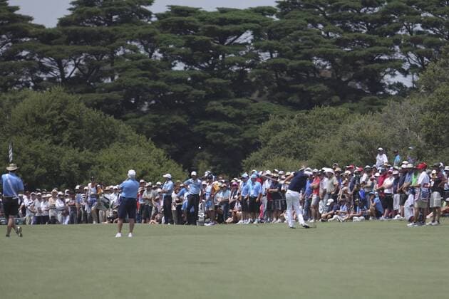 17 November 2011 : Nick Watney plays an iron shot in front of the large crowd on the first hole during the 1st day Foursomes Matches at the Presidents Cup at the Royal Melbourne Golf Club in Melbourne, Australia. PGA Golf Herren NOV 17 Presidents Cup - Day 1 Foursomes matches Icon111117013 EDITORIAL USE ONLY