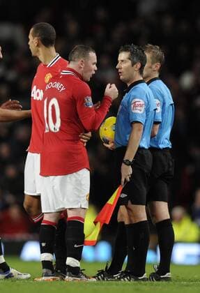 Wayne Rooney of Manchester United confronts linesman John Flynn at the end of the match Barclays Premier League Manchester United v Newcastle United 26th November, 2011 EDITORIAL USE ONLY. No use with unauthorised audio, video, data, fixture lists, club league logos or live services. Online in-match use limited to 120 images, no video emulation. No use in betting, games or single club league player publications.