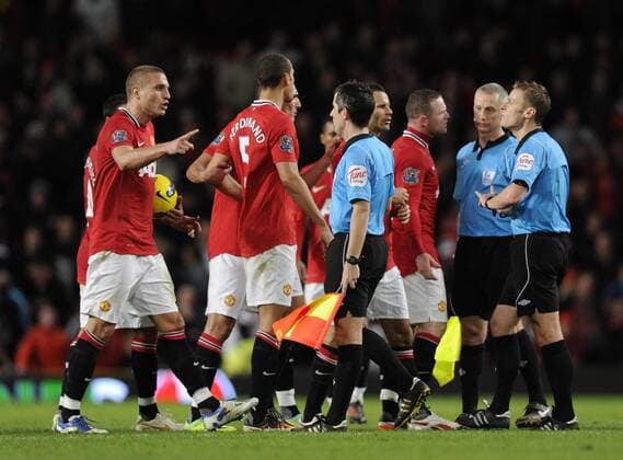 Manchester United players confront the referee and the linesman at the end of the match Barclays Premier League Manchester United v Newcastle United 26th November, 2011 EDITORIAL USE ONLY. No use with unauthorised audio, video, data, fixture lists, club league logos or live services. Online in-match use limited to 120 images, no video emulation. No use in betting, games or single club league player publications.