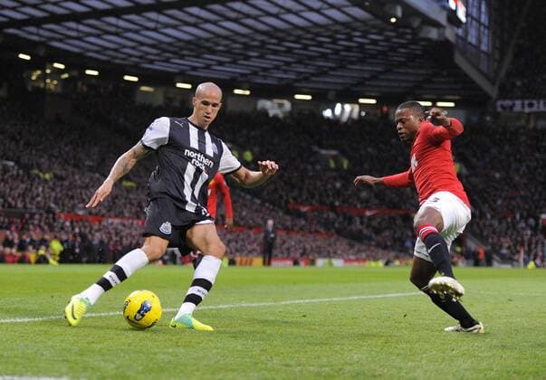 Gabriel Obertan of Newcastle United crosses the ball past Patrice Evra of Manchester United Barclays Premier League Manchester United v Newcastle United 26th November, 2011 EDITORIAL USE ONLY. No use with unauthorised audio, video, data, fixture lists, club league logos or live services. Online in-match use limited to 120 images, no video emulation. No use in betting, games or single club league player publications.