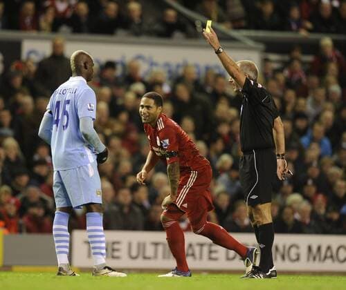 Mario Balotelli of Manchester City receives his first yellow card as Glen Johnson of Liverpool laughs Barclays Premier League Liverpool v Manchester City 27th November, 2011 EDITORIAL USE ONLY. No use with unauthorised audio, video, data, fixture lists, club league logos or live services. Online in-match use limited to 120 images, no video emulation. No use in betting, games or single club league player publications.