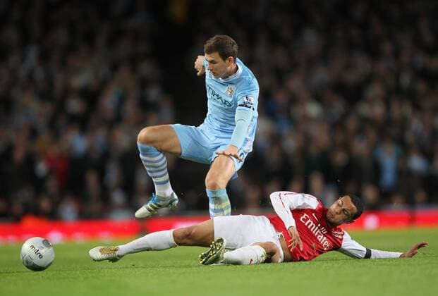 Arsenals Francis Coquelin tussles with Manchester Citys Edin Dzeko Carling Cup quarter final Arsenal v Manchester City 29th November, 2011 EDITORIAL USE ONLY. No use with unauthorised audio, video, data, fixture lists, club league logos or live services. Online in-match use limited to 120 images, no video emulation. No use in betting, games or single club league player publications. o0 Carling Cup Ligapokal